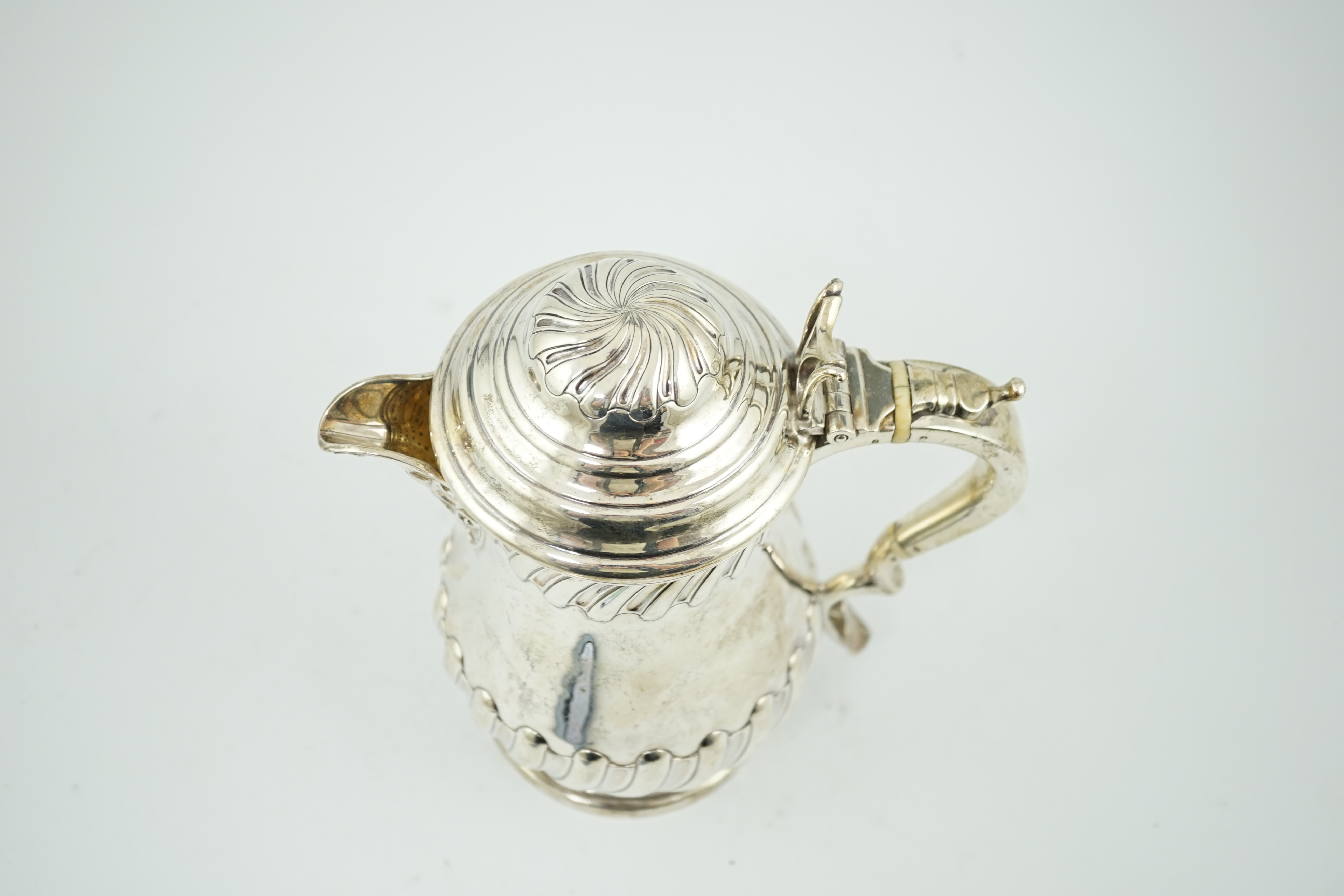 A late Victorian demi fluted wrythened silver hot water pot, by Thomas Bradbury & Sons, CITES Submission reference 8TFTTCSJ